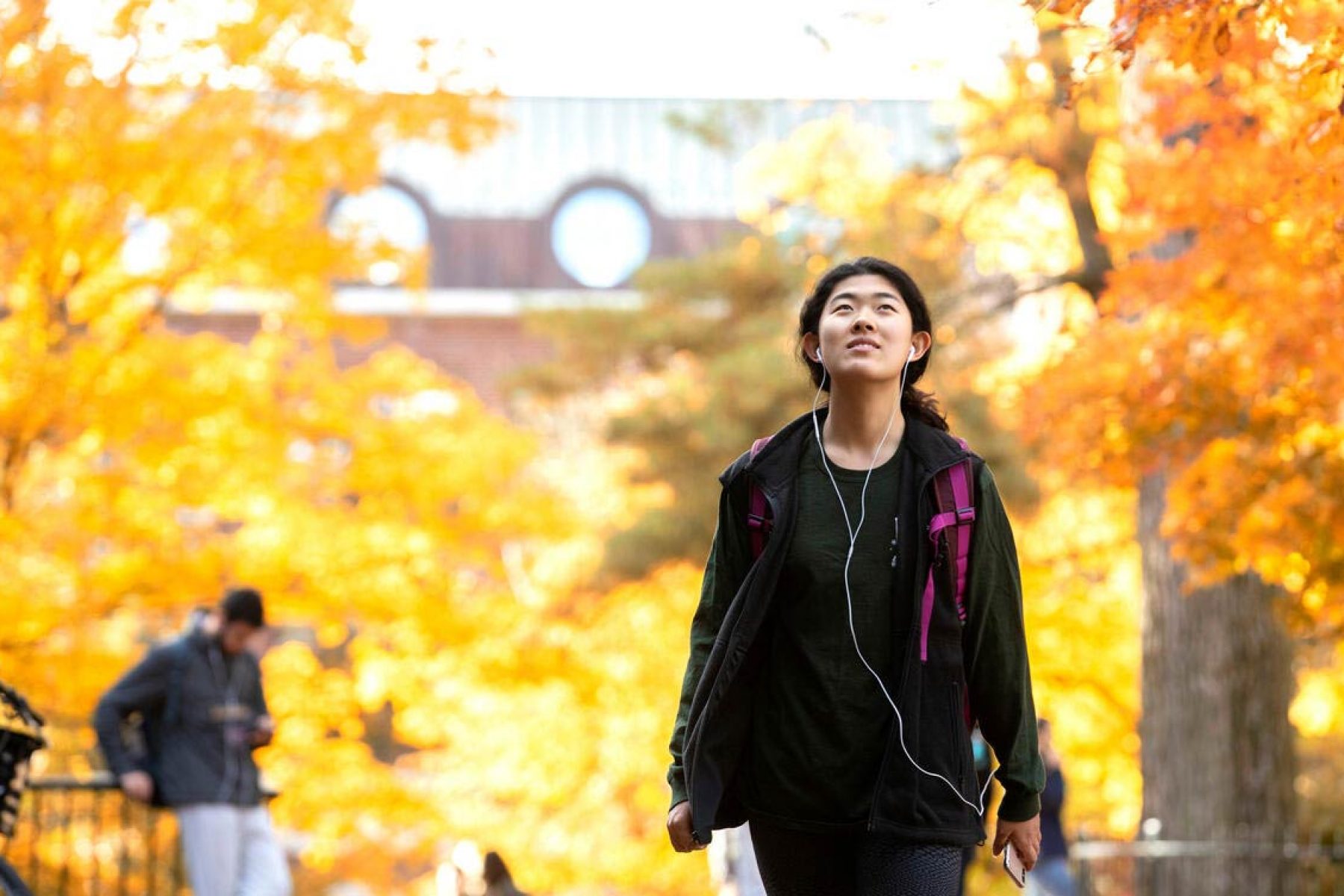 Student walking through fall campus